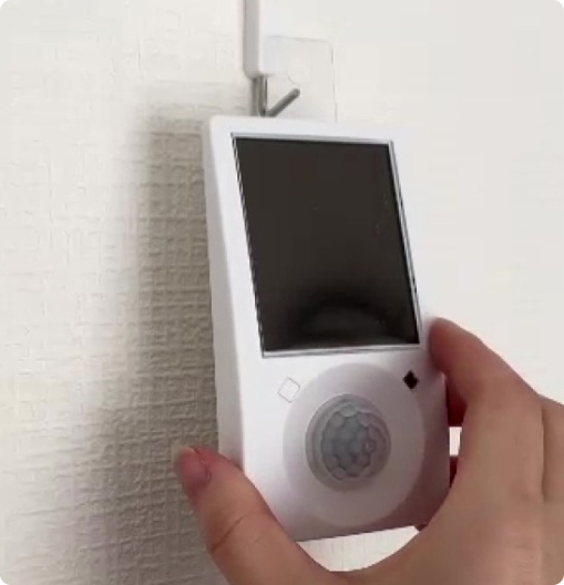 センサーをトイレに張り付けている画像